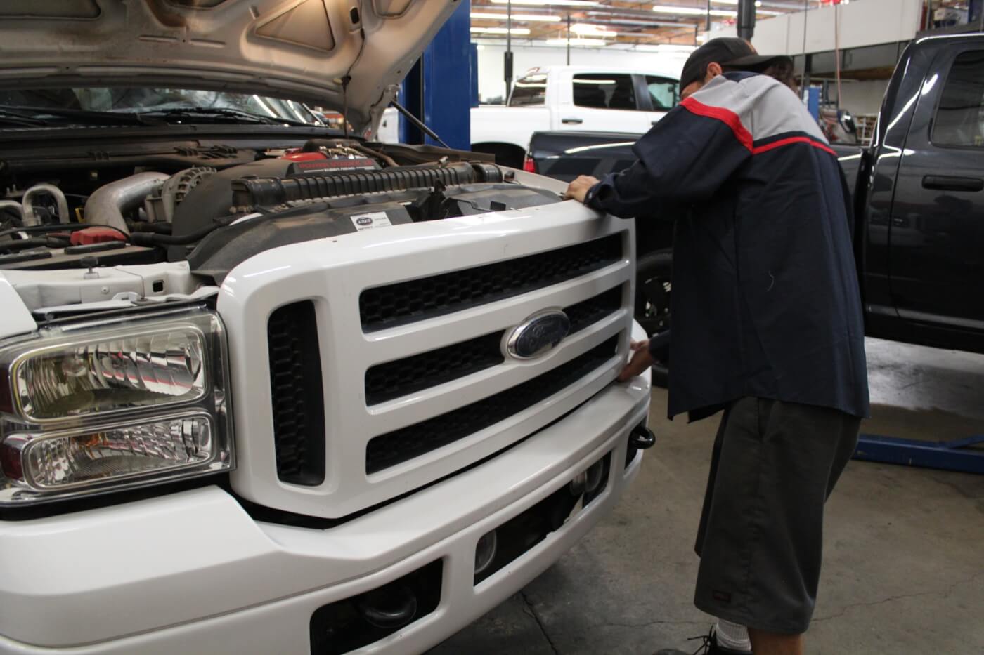 2. Just like last month's bumper installation, Brett Corder of 4Wheel Parts Wholesaler is fitting the grille to our F-250. He starts by unbolting the stock grille, which is held in place with four small bolts along the top and retaining clips along the bottom. The grille must be removed with care, as the shell will be re-used.