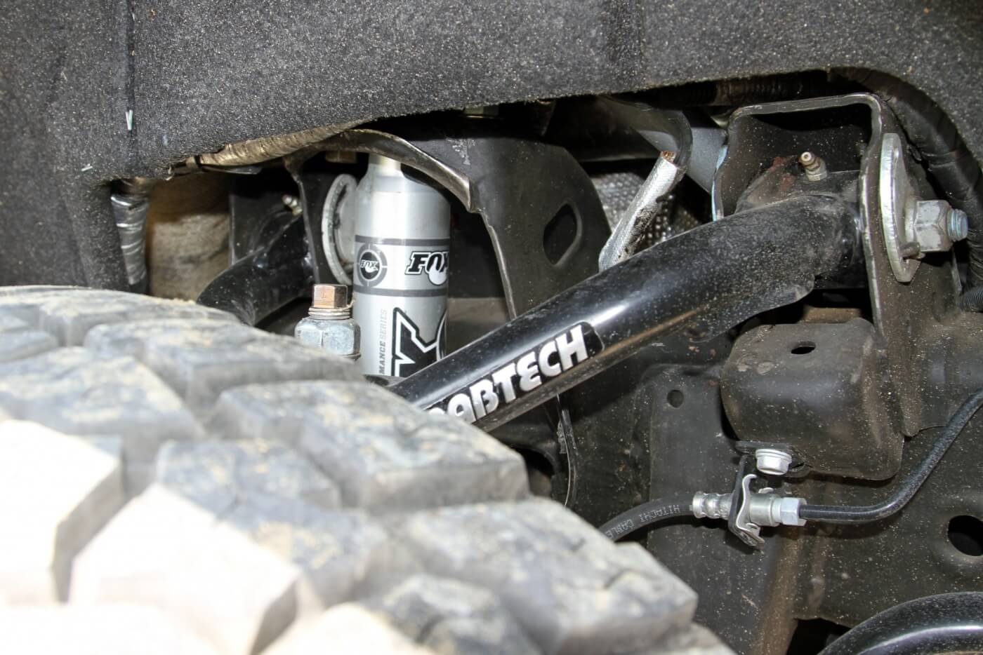 The front suspension features a 4-inch Fabtech lift kit modified to provide 3 inches of lift as well as Fabtech Uniball control arms and Fox Racing Shox. Cognito idler and pitman arm braces beef up the steering system.