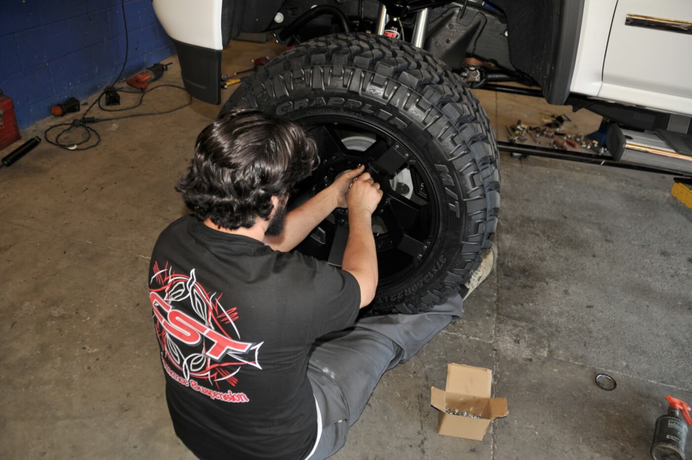 21. The 22-inch KMC XD-Series wheels and 37-inch Nitto Terra Grappler tires are mounted, balanced and installed on the truck.