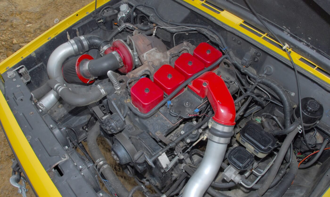 The original air horn was too close to the hood and pointed in the wrong direction. To cure this, Bankston removed the intake heating grid and milled down the four-bolt flange, then bolted up a 6BT air horn, which points in the right direction. The intercooler is half of a 6.0L Power Stroke unit with the end tanks from a Ford F-700 soldered on. These tanks used 3-inch connections and Don used 3-inch mandrel tubes from a Dodge van exhaust to plumb it all up.