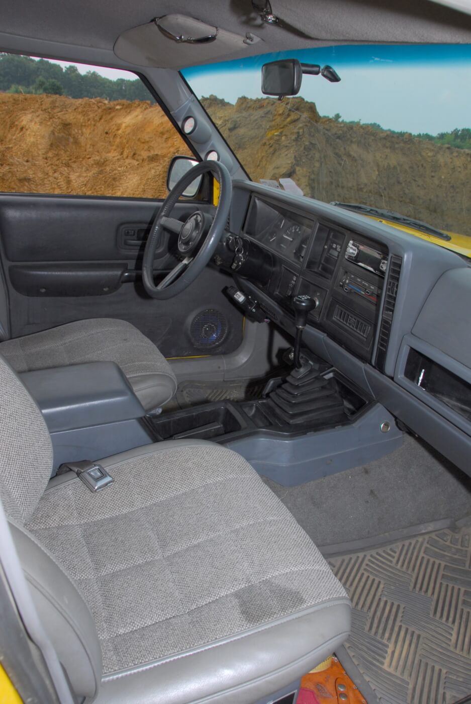 Most of the interior comes from a Cherokee. The center console had to be modified to fit the NV-4500 shifter, which comes through the floor several inches forward of where the stock manual shifter would have been. Bankston relocated the parking brake lever from the floor to the console position.