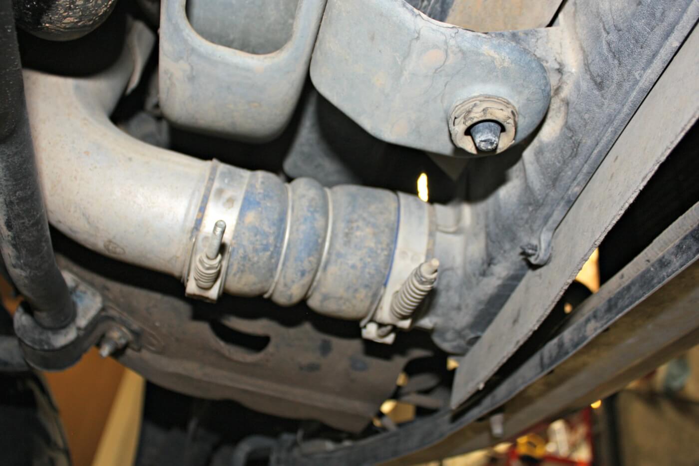 2. The driver’s side intercooler tube attaches from the underside of the truck, directly behind the bumper. Take the time to clean debris and oil out of the pipe and boot in order to ensure a leak-free seal during reassembly. This connection is notorious for coming apart and causing a loss of boost pressure.