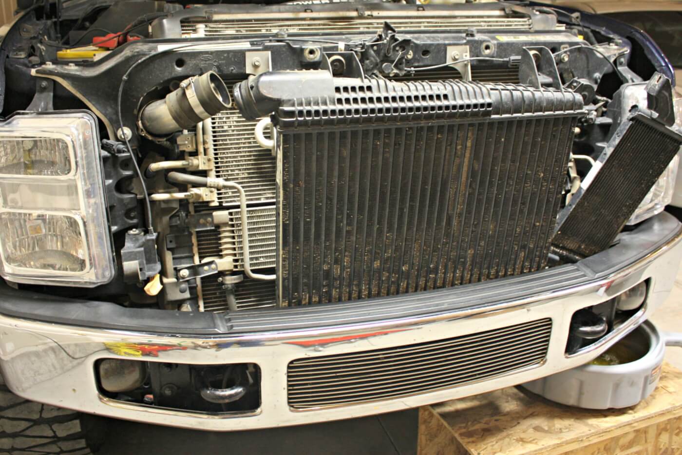 5. If there’s a cooler attached to the driver's side of the intercooler, remove it as well. The intercooler can be lifted straight up out of its lower supports. With the intercooler removed, the transmission cooler and A/C condenser can be moved aside.