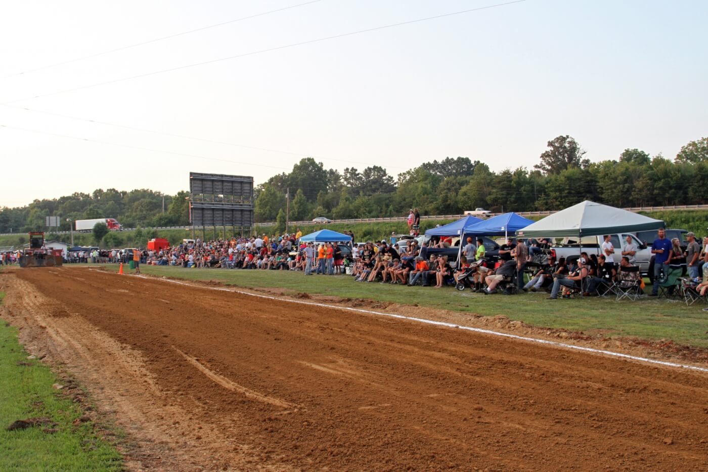 Spectators line the freshly laid pulling track waiting for the action to begin. The temporary grandstands filled quickly, forcing spectators to overflow onto the rest of the grounds.