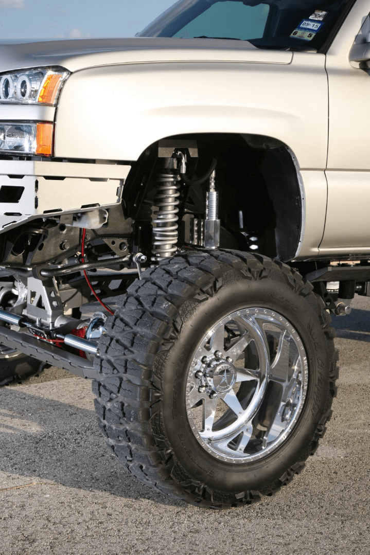 The Chevy rides on 22" American Force Evade FP8 wheels with Nitto Mud Grappler tires, while 2-inch spacers give the truck its aggressive stance, and the shocks are 12-inch coilovers from Fox.