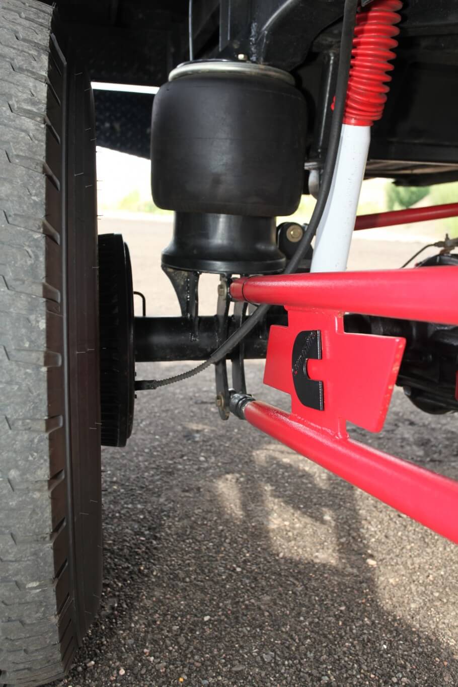 A pair of heavy-duty Firestone air springs were stripped off a Kenworth semi truck and used on this build. Custom mounting perches were fabricated for the “bags” along with mounting brackets for the three-link traction bars. A pair of Rancho 9000 adjustable shocks were re-shimmed and re-valved for better off-road performance. 