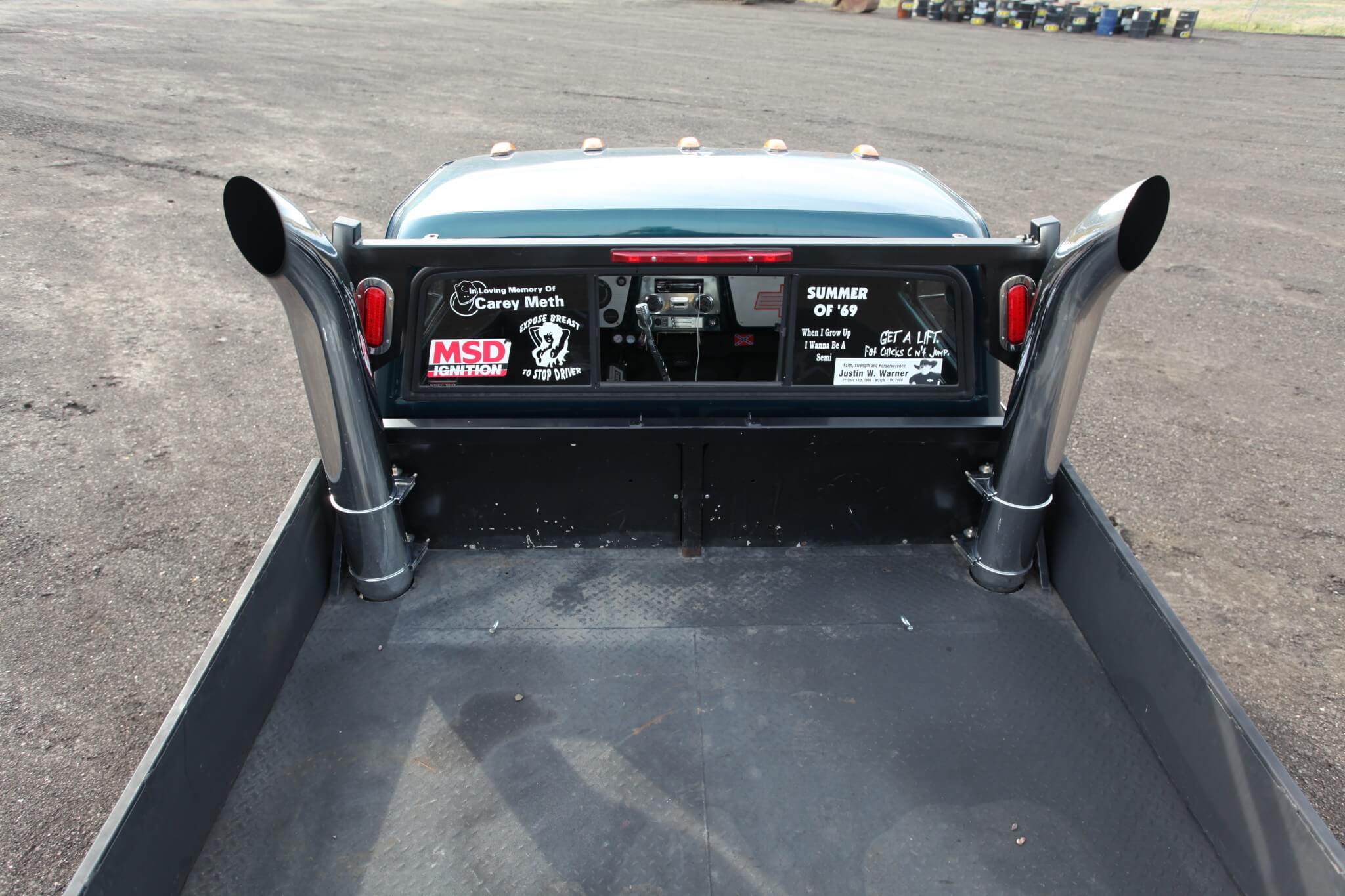 Two 6-inch vertical exhaust stacks exit through the flatbed floor.